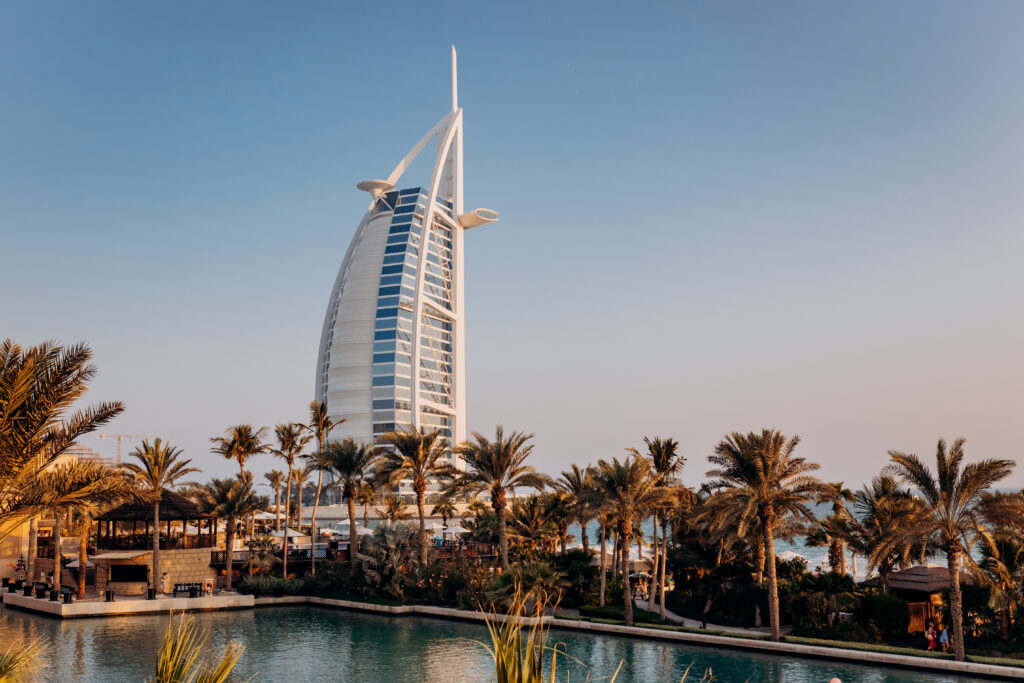 Dubai, UAE - November 04, 2021: The view of the Burj Al Arab hotel from Madinat Jumeirah in Dubai at sunset. Luxury modern architecture and tourism concept.