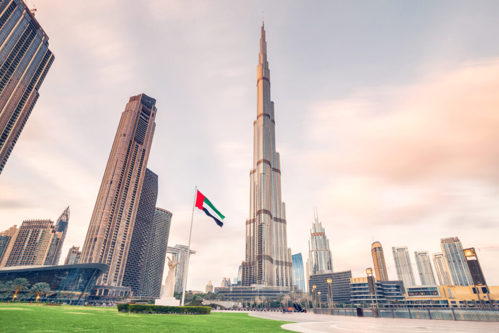 Scenic view of Dubai skyline, with the Burj Khalifa towering over all other buildings and motion blur of flying clouds. Sightseeing and travel destinations in Arab Emirates
